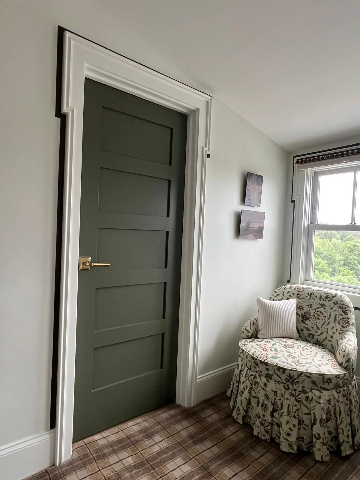 Interior door with casing, hardware, and window trim installed