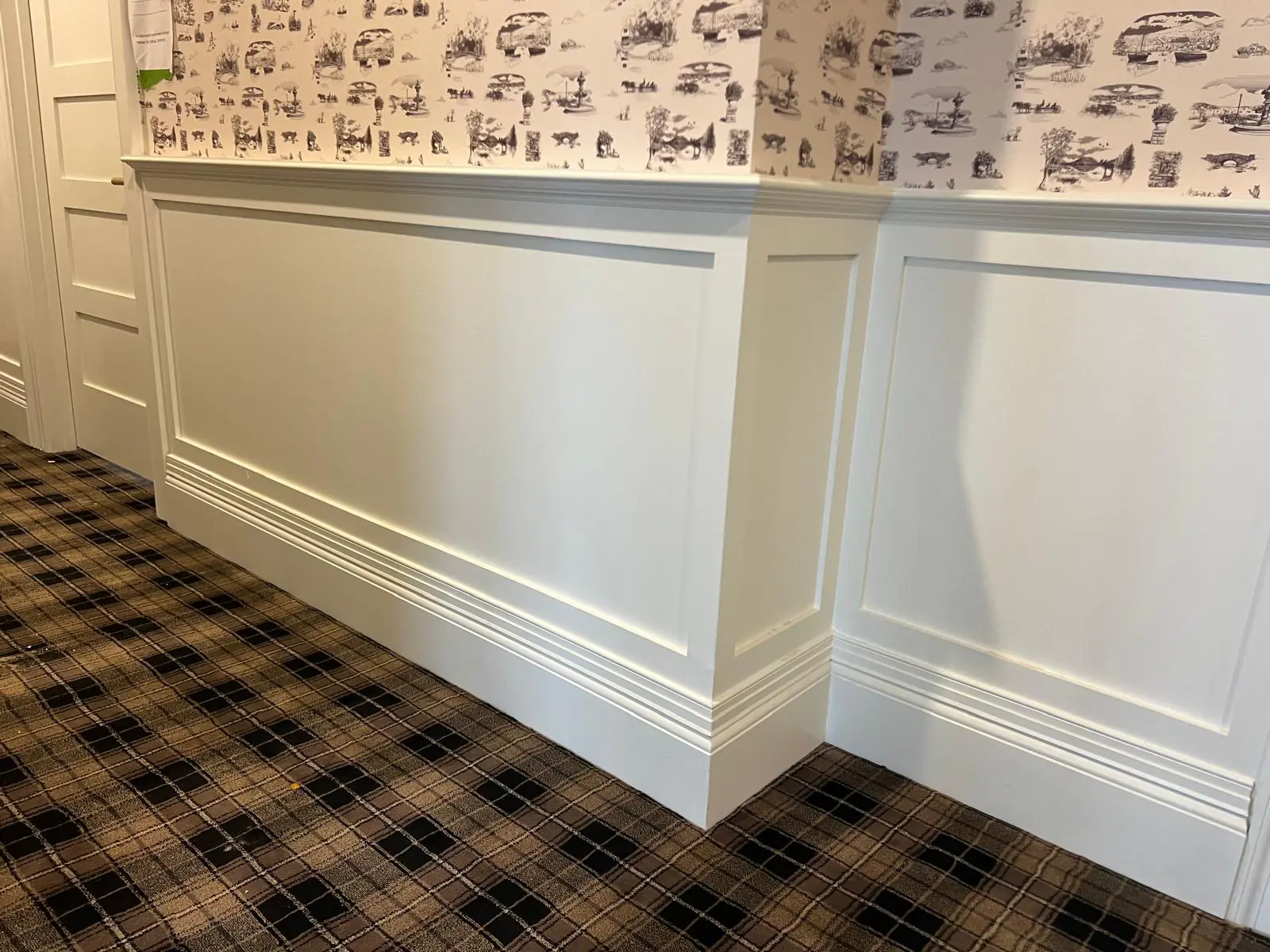 Commercial corridor with wainscot paneling and base installed