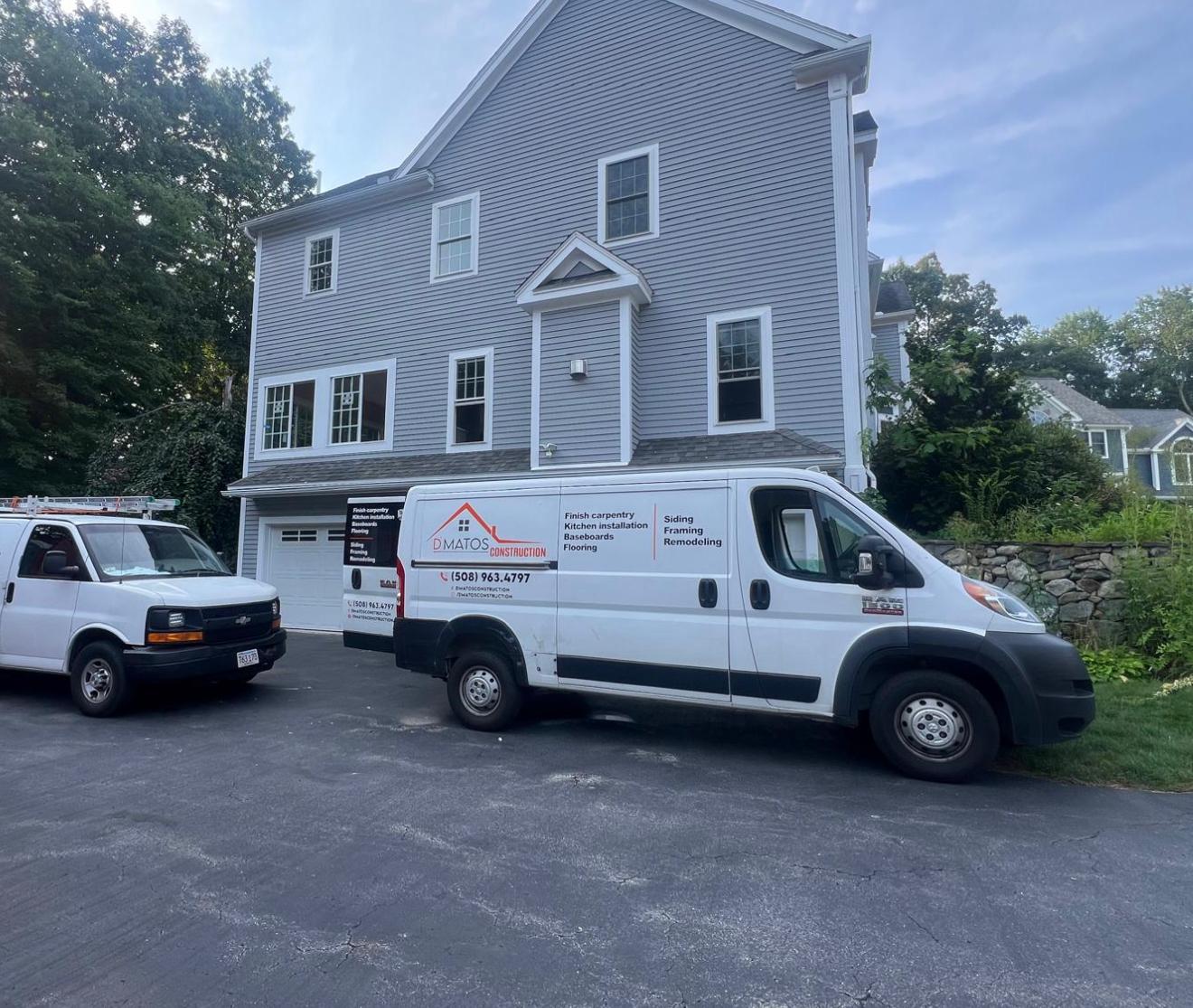 D'Matos Construction van on a siding jobsite